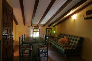 a living room with a table and a couch at Comfortable Apartment in Robledillo de Gata with Balcony and View in Robledillo de Gata