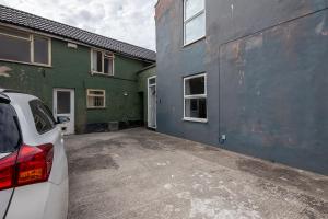a car parked in a parking lot next to a building at Spacious 2BR APT - Sleeps 5 - Private Parking in Highbridge