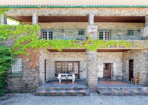 a stone house with a table in front of it at Charming Villa with Private Pool in Lamego in Lamego