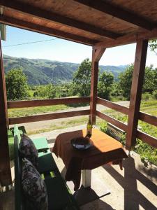 a table and chairs on a porch with a view at Cottage in nature Bare, Savnik in Šavnik