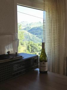 a bottle of wine sitting on a table next to a window at Cottage in nature Bare, Savnik in Šavnik