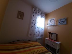 a small bedroom with a bed and a window at Appartement charmant à Bandol 30 m² avec vue sur la mer. in Bandol +17 photos