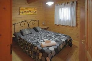 a bedroom with a bed in a log cabin at Charming Bungalow in Tarifa with Mountain View in Tarifa