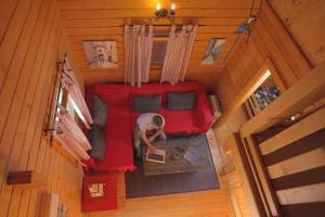 an overhead view of a person sitting on a red couch at Charming Bungalow in Tarifa with Mountain View in Tarifa