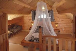 a bedroom with a bed in a log cabin at Charming Bungalow in Tarifa with Mountain View in Tarifa