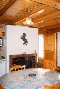 a dining room with a table and a fireplace at Chalet cosy à Sixt-Fer-à-Cheval avec vue sur la montagne in Sixt