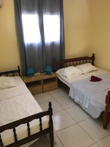 a bedroom with two beds and a window at Appartement avec vue sur la mer à Le Marin, Climatisé, 80 m² in Le Marin +15 photos
