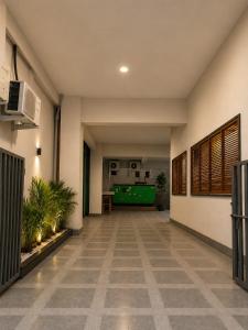 a hallway with a pool table in a building at Hotel Pride in Wardha