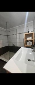 a bathroom with a sink and a glass shower at Spacious stay in Preveza