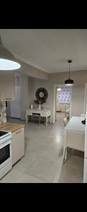a kitchen and living room with a table and chairs at Spacious stay in Preveza +10 photos