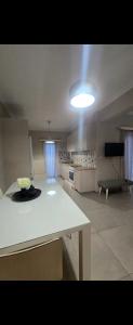 a living room with a white table and a light at Spacious stay in Preveza