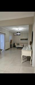 a living room with a couch and a table at Spacious stay in Preveza