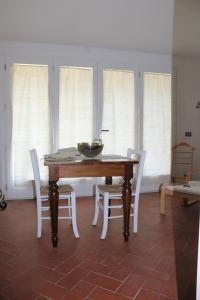 a dining room with a table and chairs and windows at Agriturismo Abbonbri in Quarrata +13 photos
