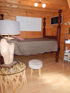 a bedroom with a bed and a table and a chair at Chalet confortable au Vauclin avec piscine privée in Le Vauclin