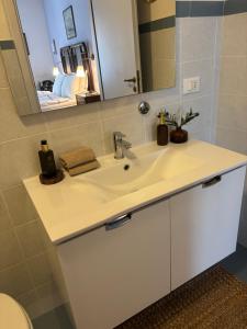 a bathroom with a white sink and a mirror at Art & Breakfast in Ripabottoni