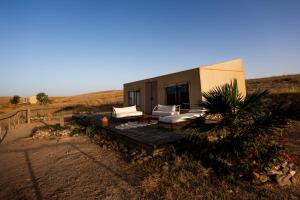a small house in the middle of a field at Dar Inacamp in El Mjed