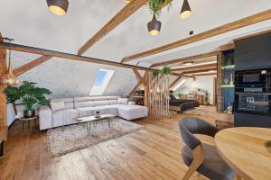 a living room with a couch and a table at Apartmány Wake up Coffee in Proseč
