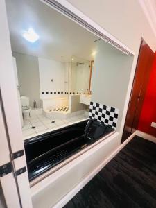 a bathroom with a mirror and a sink and a toilet at Innscape Classic Hotel in Cape Town