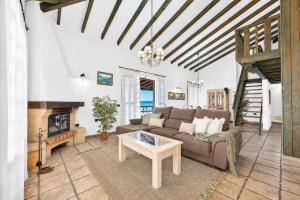a living room with a couch and a fireplace at CERCADO DEL MEDIO, CHALET con PISCINA PRIVADA in Adeje