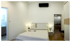 a bedroom with a white bed with two lights on it at Elegant Villa in Outes with Pool in Serantes +14 photos