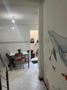 a room with a table and a dining room with a shark on the wall at Preservar hostel in Cabo Frio +19 photos