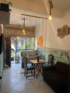 a living room with a table and a couch at Preservar hostel in Cabo Frio
