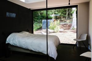 a bedroom with a bed and a sliding glass door at Cit'Art in Namur