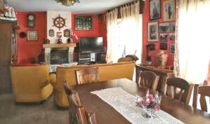 a dining room with red walls and a table and chairs at Elegant Villa in Tui with Private Pool in Tui