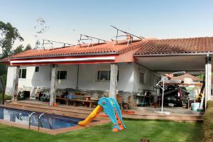 a house with a pool and a slide in the yard at Elegant Villa in Tui with Private Pool in Tui