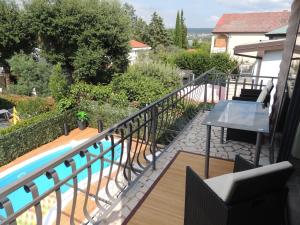 a balcony with a view of a swimming pool at Welcoming Villa in Vantačići with Pool and Sea View in Vantačići