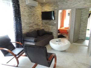 a living room with a couch and a chair at Welcoming Villa in Vantačići with Pool and Sea View in Vantačići