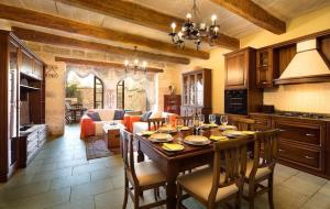 a kitchen and living room with a table and chairs at Exceptional villa in In-Nadur with private pool. in Nadur