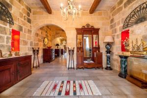 a large room with a large stone wall at Exceptional villa in In-Nadur with private pool. in Nadur