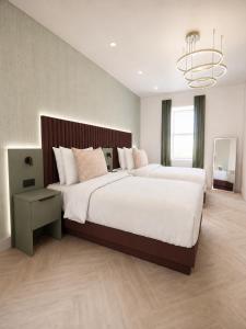 a large bedroom with two beds and a chandelier at The View from BIDE in Thurso
