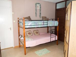 a bedroom with two bunk beds in a room at Charming Apartment in Pamplemousses, 30 m² with Garden View in Pamplemousses Village