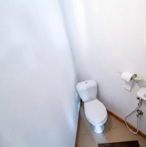 a bathroom with a toilet and a roll of toilet paper at Charming Apartment in Pamplemousses, 30 m² with Garden View in Pamplemousses Village