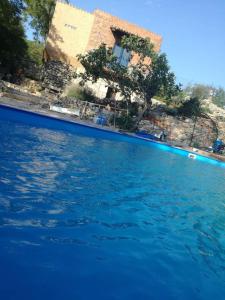a swimming pool with blue water in front of a house at Charming Villa in Filozići with Private Pool in Filozići +18 photos