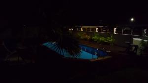 a view of a swimming pool at night at Studio accueillant à Baie Mahault, 22 m², piscine partagée. in Baie-Mahault +7 photos