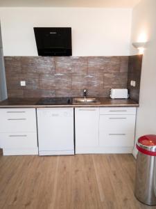 a kitchen with a sink and a microwave at Appartement lumineux à Saint-Cyprien 45 m² vue mer in Saint-Cyprien