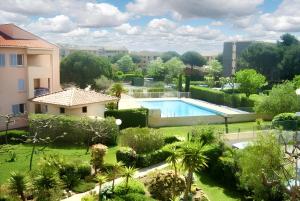 a view of a garden with a swimming pool at Studio charmant à Fréjus avec piscine commune - 30 m² in Fréjus