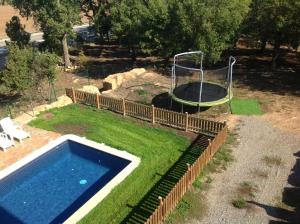 a pool in a yard with a trampoline at Charming Villa in Llobera with Private Pool in Llanera