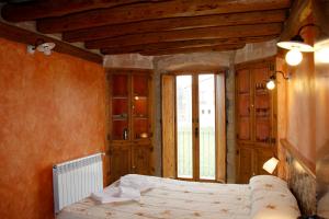 a bedroom with a bed and a large window at Charming Villa in Llobera with Private Pool in Llanera