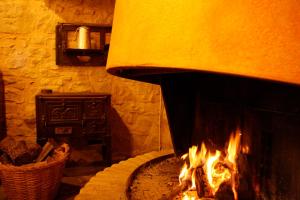 a stone oven with a fire in it at Charming Villa in Llobera with Private Pool in Llanera