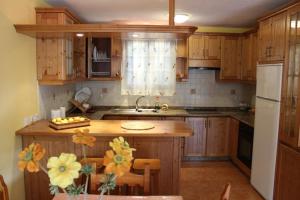 a kitchen with wooden cabinets and a kitchen island at Cosy chalet with panoramic views in Icod de los Vinos - 70m² in Icod de los Vinos