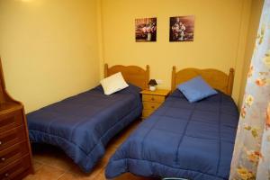 a bedroom with two beds and a dresser at Cosy chalet with panoramic views in Icod de los Vinos - 70m² in Icod de los Vinos