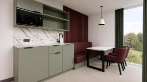 a kitchen with a counter and a table and chairs at The View from BIDE in Thurso