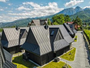 an aerial view of a house with mountains in the background at Crystal Peak Villas z prywatnym jacuzzi, Odkryj-Zakopane in Kościelisko