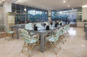 a long table and chairs in a room at Grand Tryas Hotel in Cirebon
