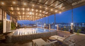 a pool on the roof of a building at night at Grand Tryas Hotel in Cirebon