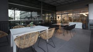 a restaurant with rattan tables and chairs at Grand Tryas Hotel in Cirebon